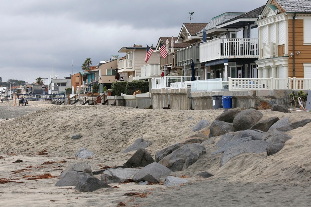 Sand-and-rock berms form a barrier along beachfront homes in Del Mar, California, March 2020. Photo by Peggy Peattie for CalMatters