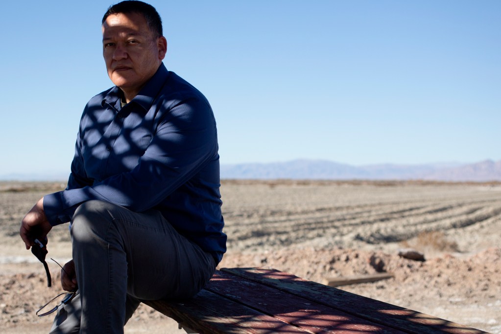 Luis Olmedo, executive director of Comite Civico Del Valle, sits for a portrait near a dried portion of the Salton Sea in Brawley on Feb. 5 2021. Photo by Shae Hammond for CalMatters