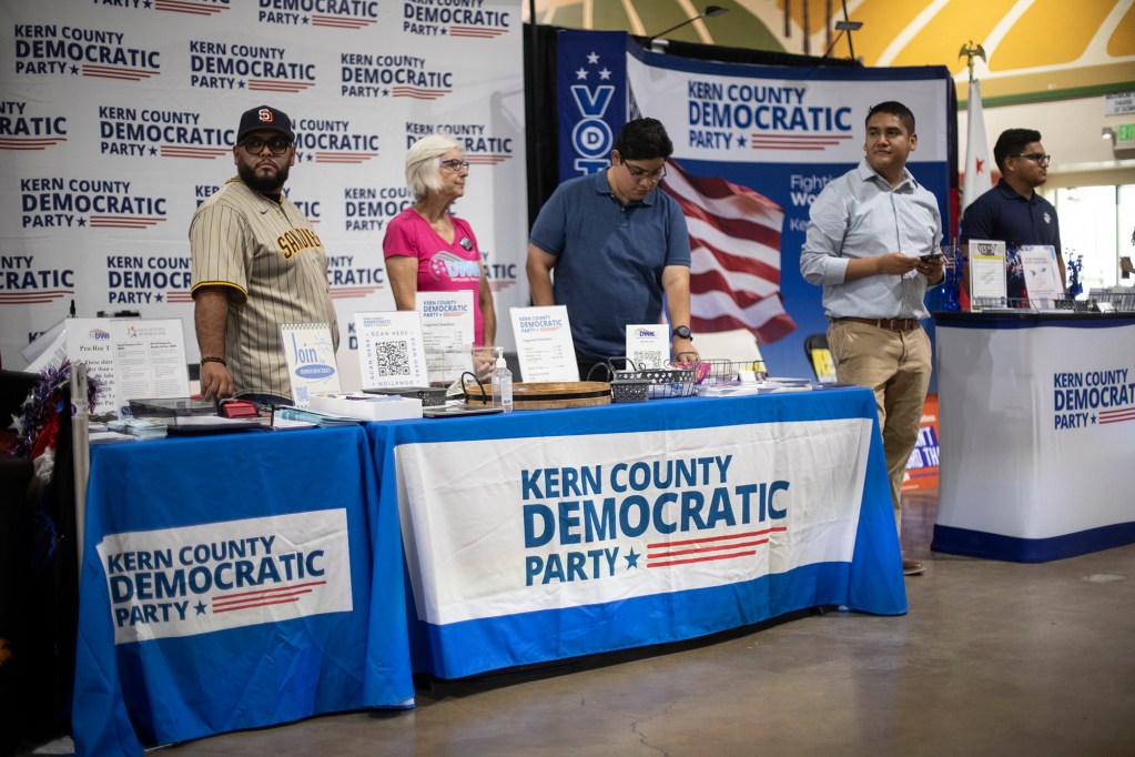 Image of Democratic Party volunteers standing ready to engage voters at the Kern County Fair