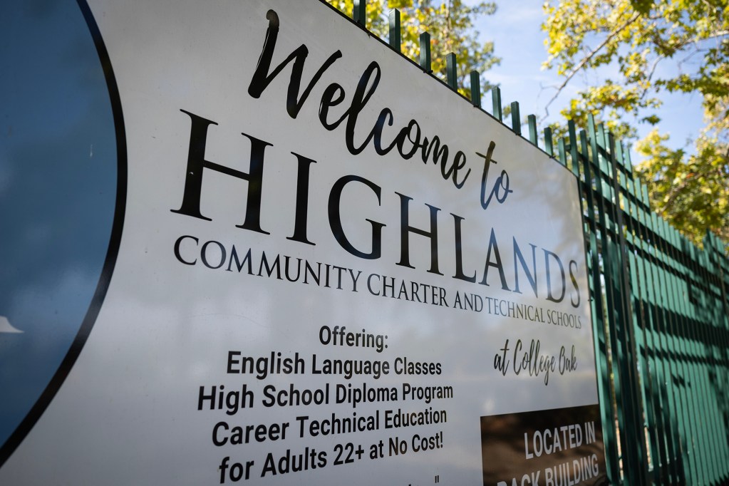 A sign for Highlands Community Charter and Technical Schools advertises English-language classes, a high school diploma program and career technical education for adults.
